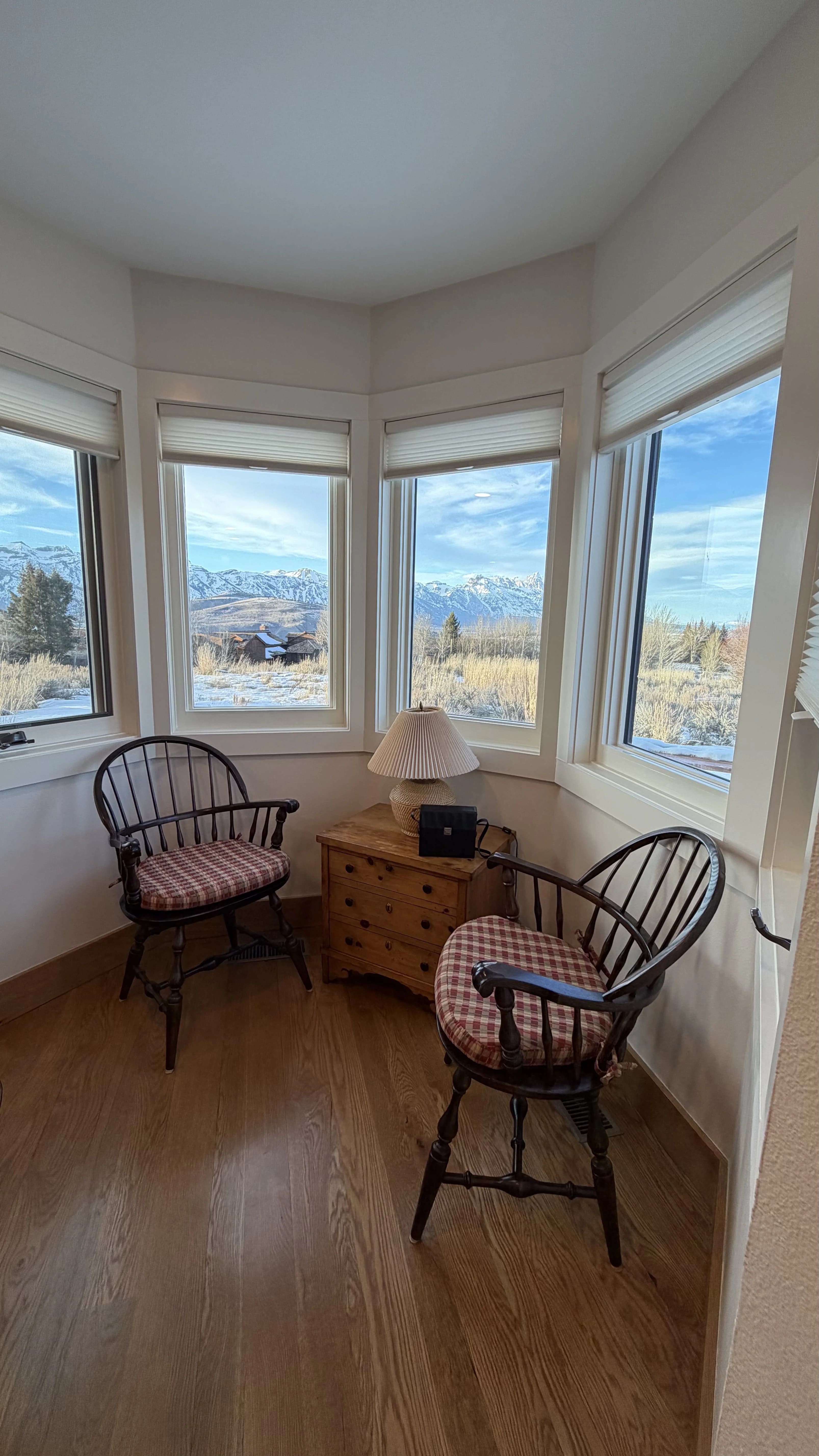 Dining room with river stone fireplace and mountain views